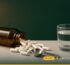 NAC supplement capsules spilling from an amber bottle beside a measuring spoon and glass of water – London Health Star UK guide to NAC amounts and how to take it